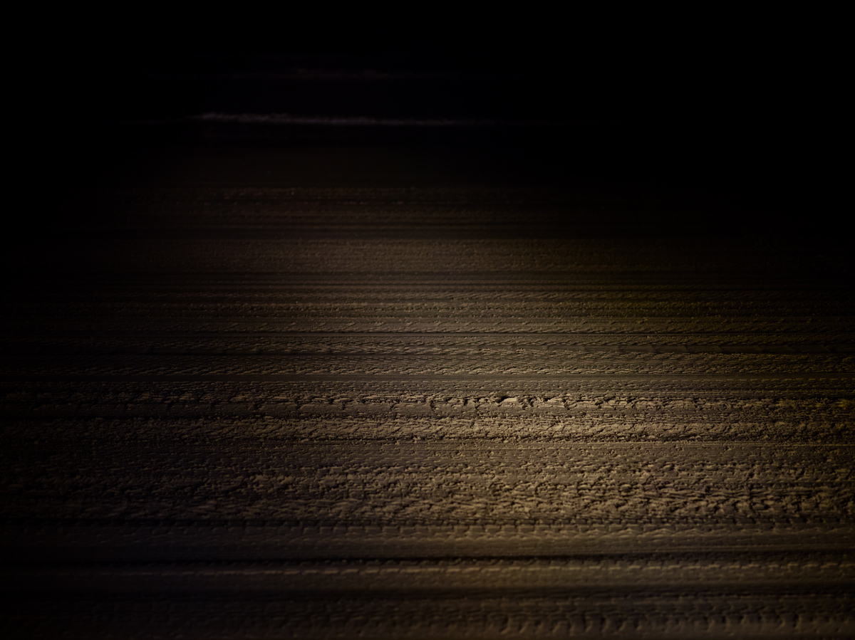 tire tracks on sand at night